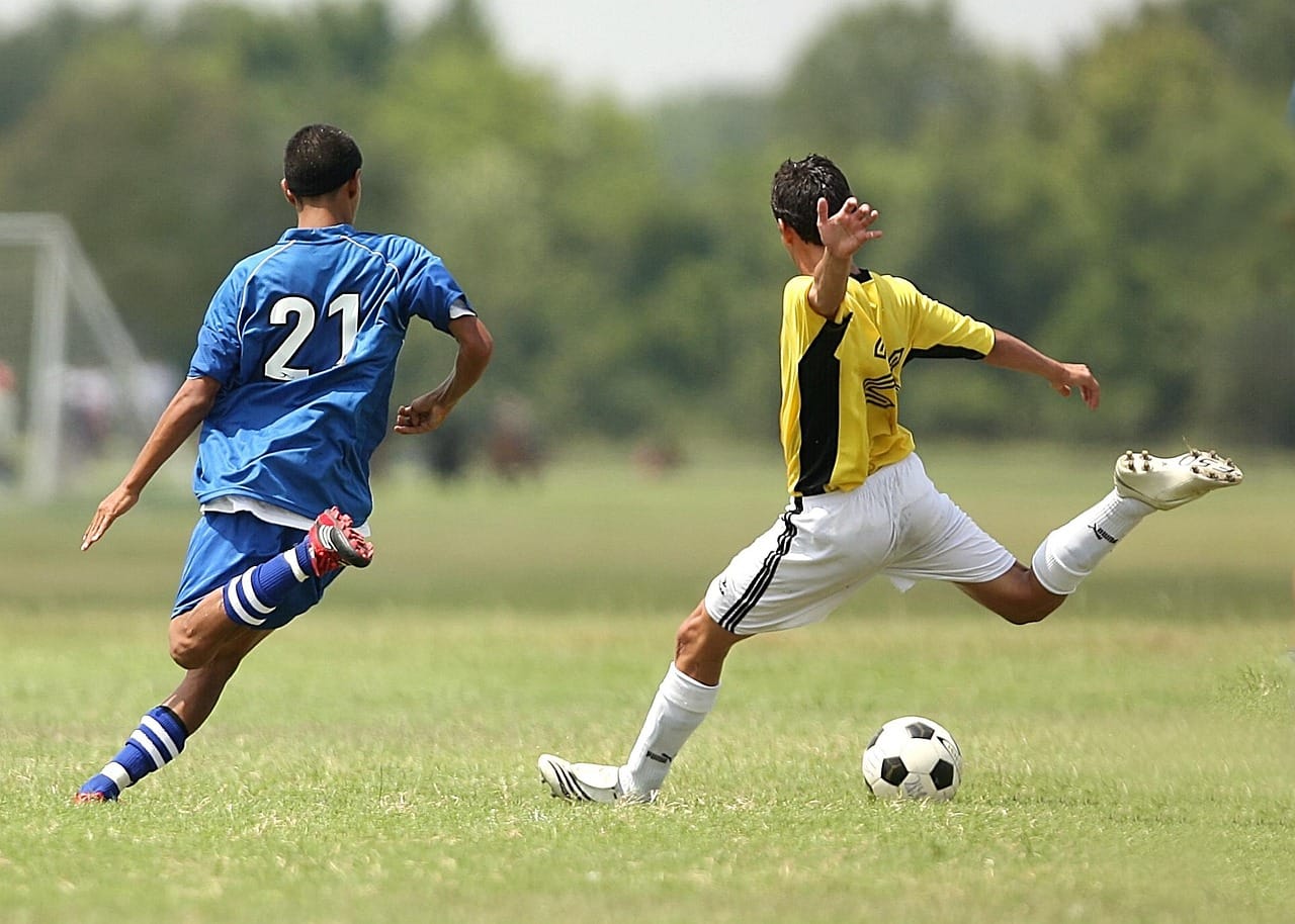 Kid sprinting with soccer ball