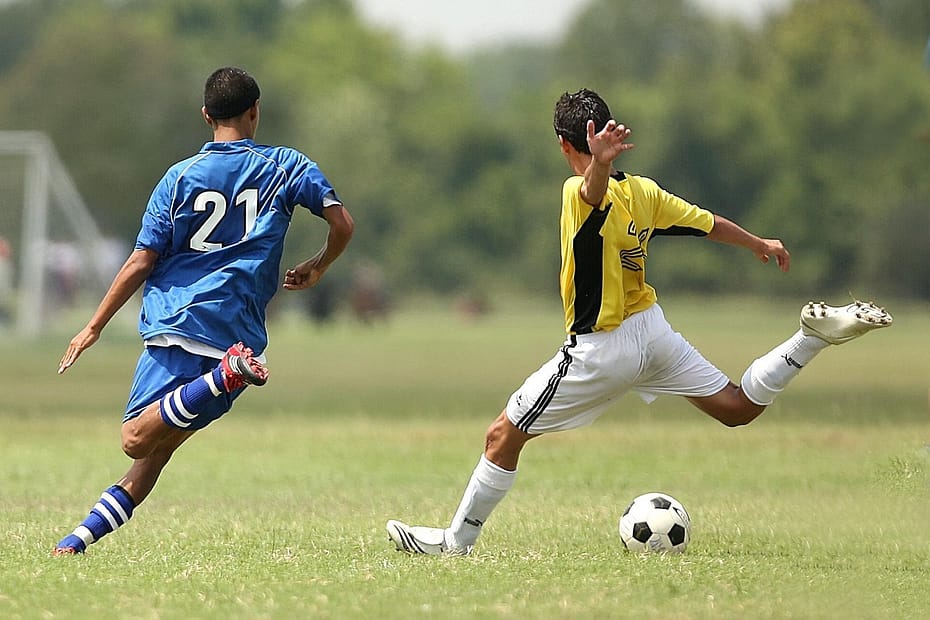 Kid sprinting with soccer ball